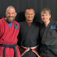 Grandmaster Scot Conway smiles with Joshua and Andrea Loya.