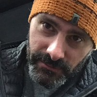 Close-up of Jason James in an orange beanie.