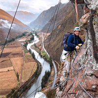 Simone Knego suspended on the side of a mountain beneath her Skylodge in Peru's Sacred Valley.